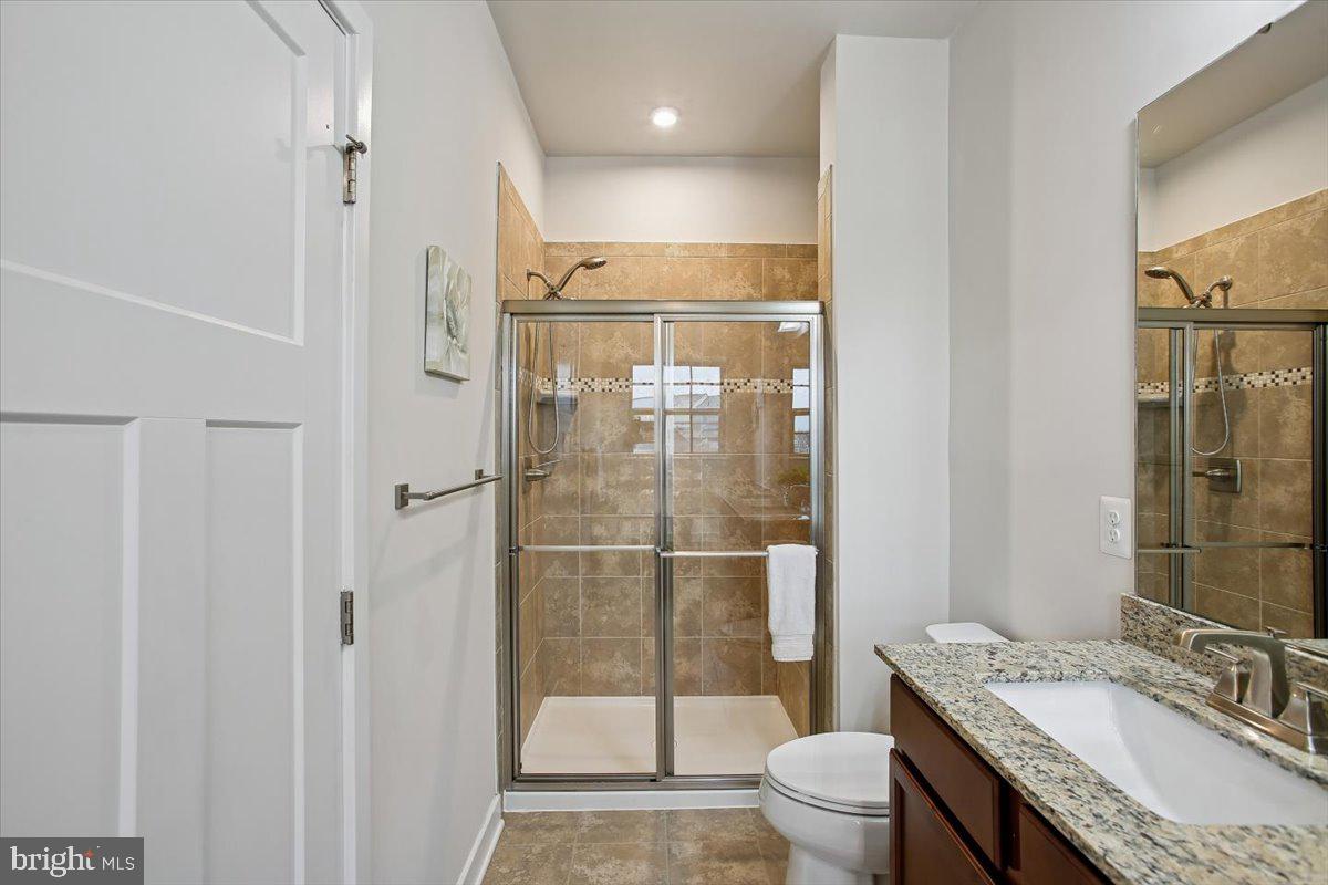 2105 Hemlock Bay Road Dumfries, VA 22026 - Photo 14 of 48 a bathroom with a granite countertop sink toilet and shower