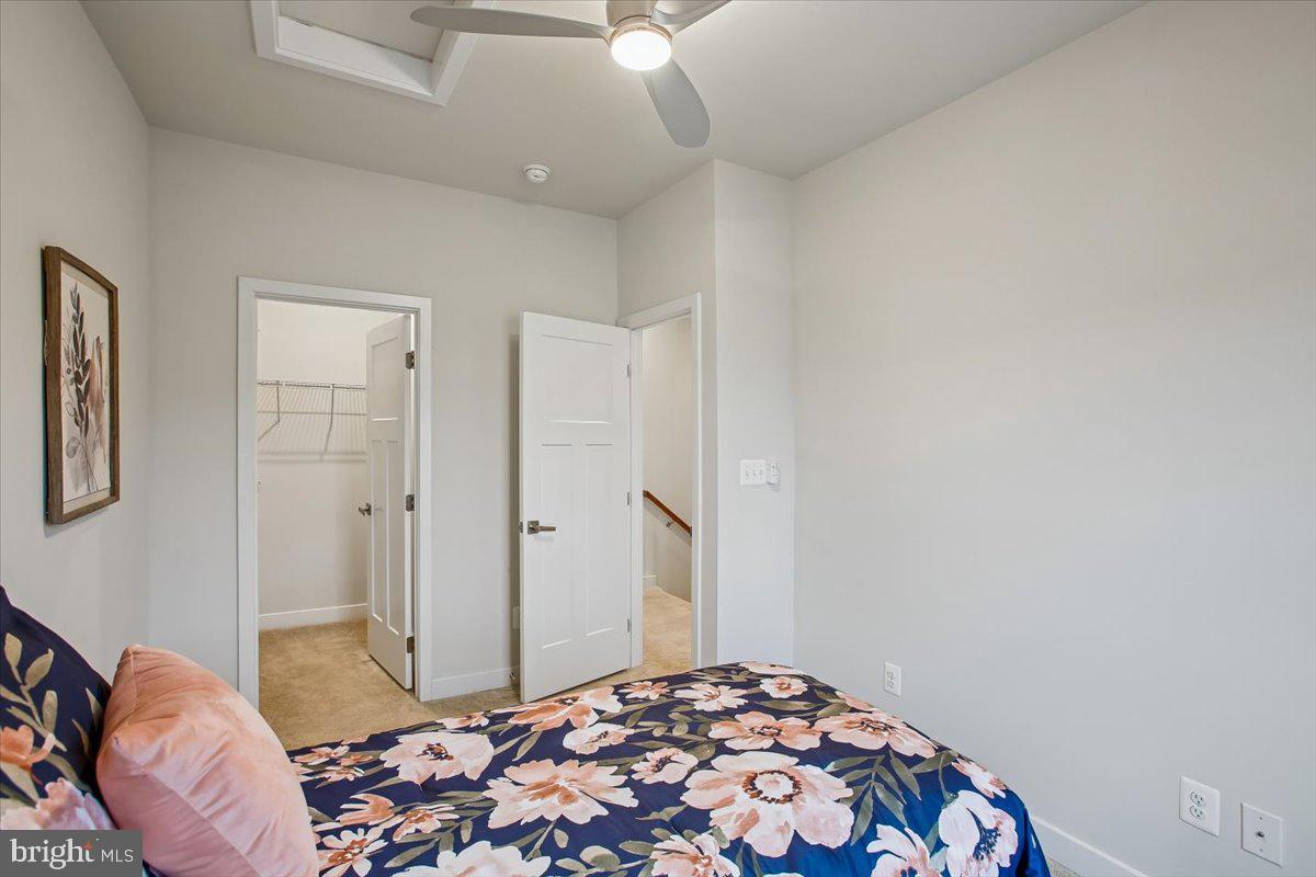 2105 Hemlock Bay Road Dumfries, VA 22026 - Photo 16 of 48 a bedroom with a bed and a chandelier