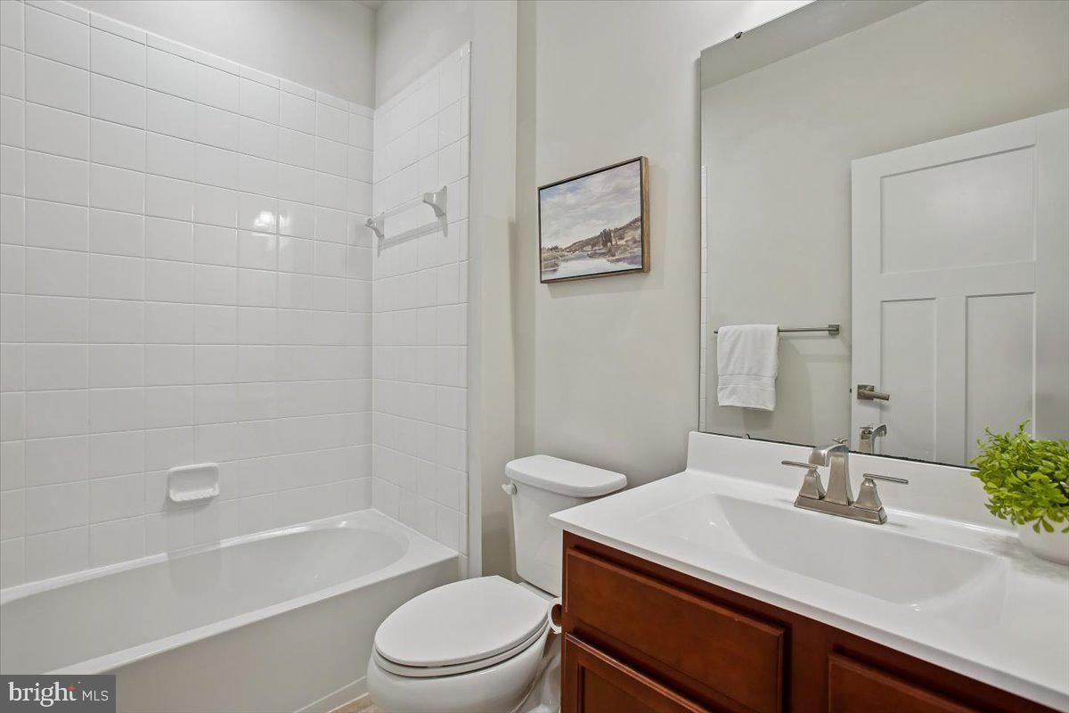 2105 Hemlock Bay Road Dumfries, VA 22026 - Photo 18 of 48 a bathroom with a sink a toilet and shower