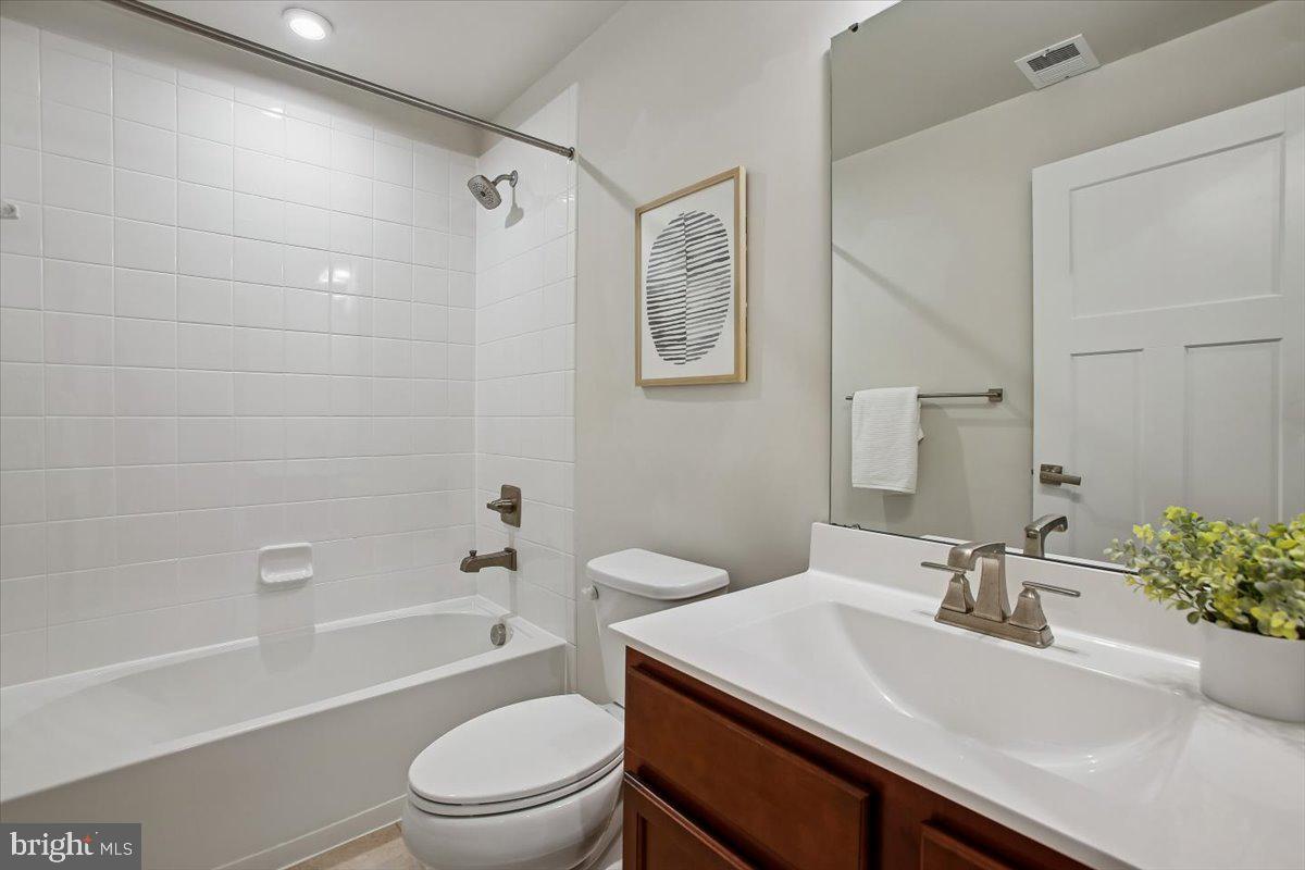 2105 Hemlock Bay Road Dumfries, VA 22026 - Photo 23 of 48 a bathroom with a sink a toilet and a bathtub