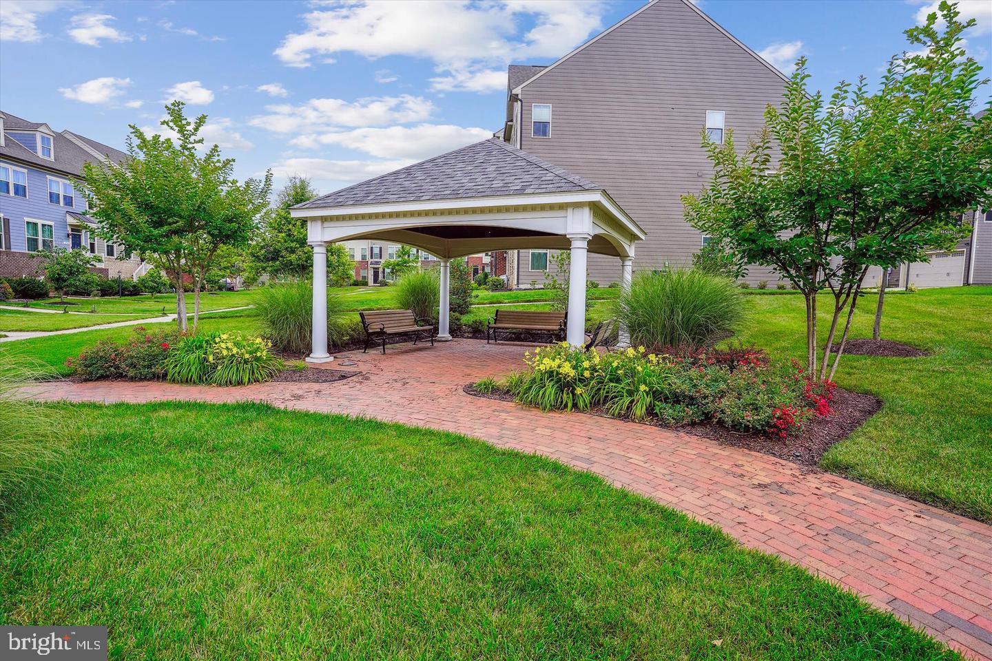 2105 Hemlock Bay Road Dumfries, VA 22026 - Photo 29 of 48 a view of a big yard in front of a brick house with large windows