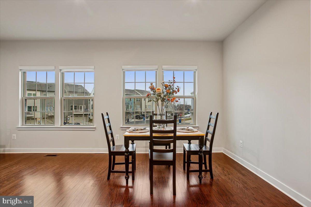 2105 Hemlock Bay Road Dumfries, VA 22026 - Photo 7 of 48 a view of a dining room with furniture window and wooden floor