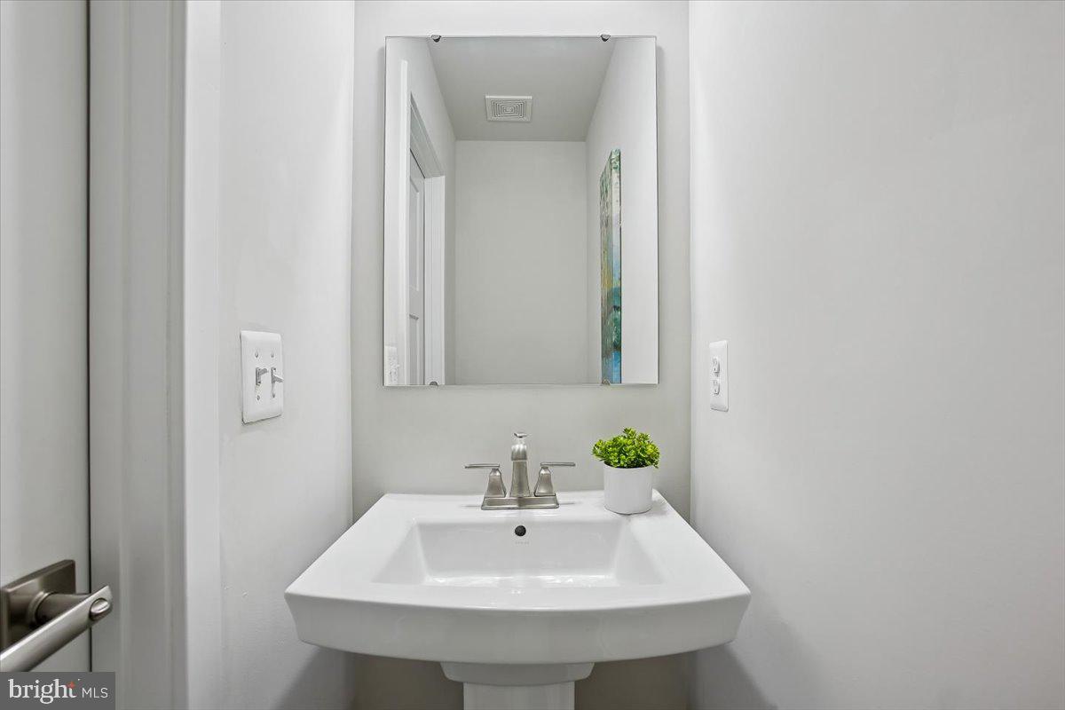 2105 Hemlock Bay Road Dumfries, VA 22026 - Photo 8 of 48 a bathroom with a sink and a mirror