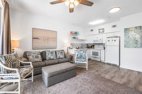 a living room with furniture and kitchen view