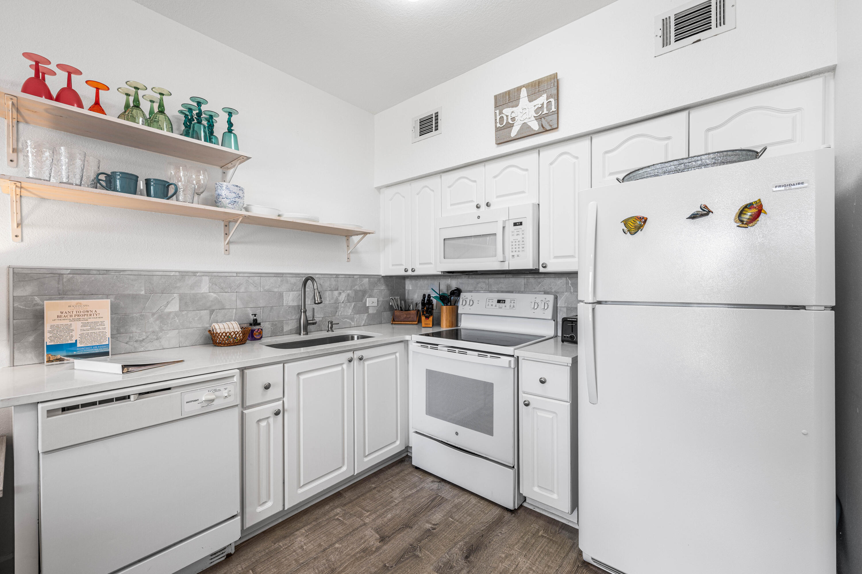 145 Spires Lane, Unit 306 Santa Rosa Beach, FL 32459 - Photo 18 of 35 a kitchen with white cabinets and white appliances