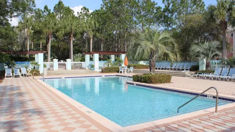 a view of swimming pool with chairs