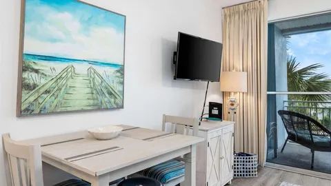 a view of a workspace with furniture and a flat screen tv