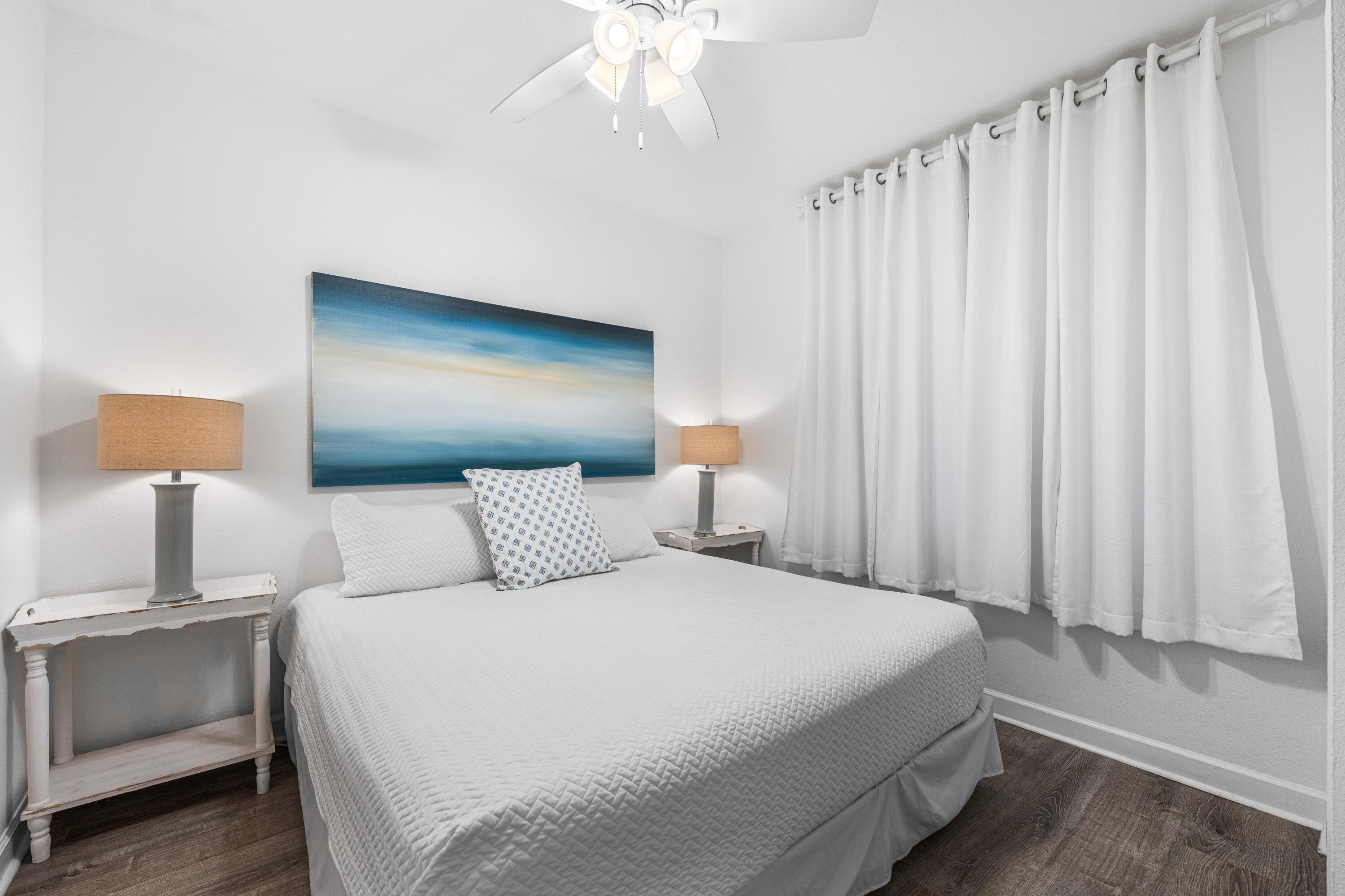 145 Spires Lane, Unit 306 Santa Rosa Beach, FL 32459 - Photo 6 of 35 a bedroom with a bed and a night stand
