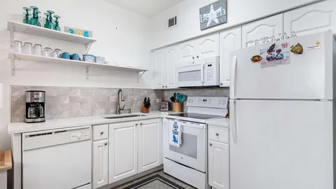 a kitchen with appliances and cabinets