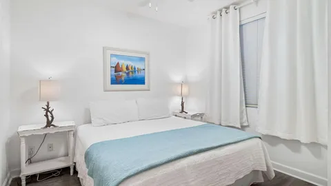 a bedroom with a bed and a painting on the wall