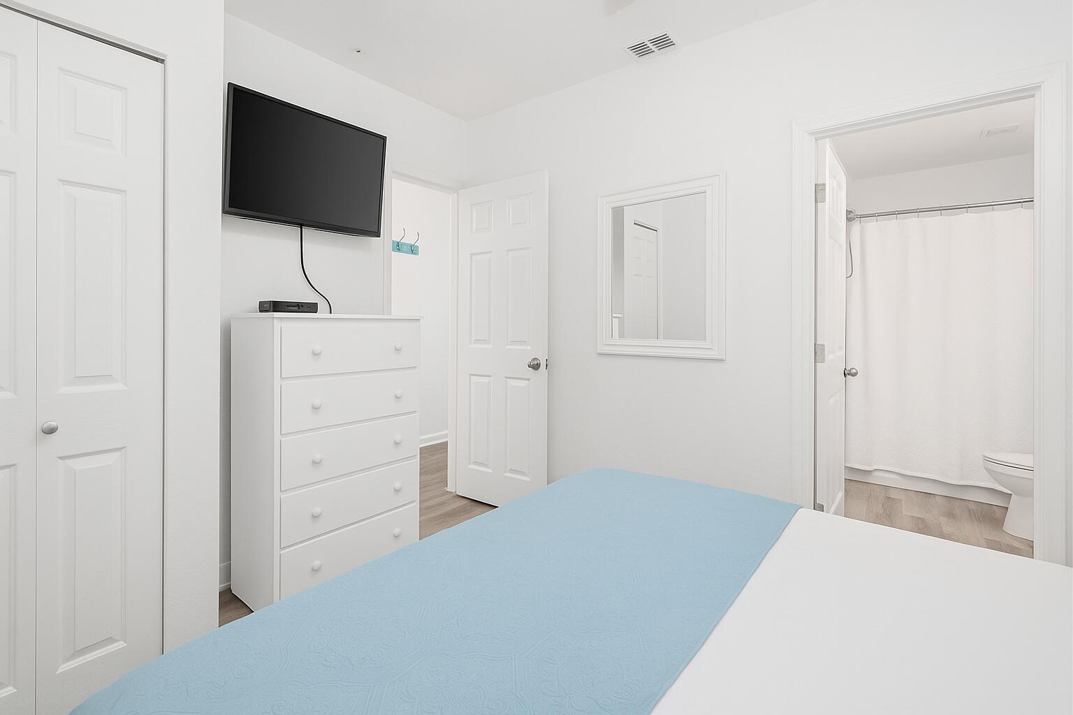 145 Spires Lane, Unit 306 Santa Rosa Beach, FL 32459 - Photo 8 of 22 a bedroom with a bed and a flat screen tv