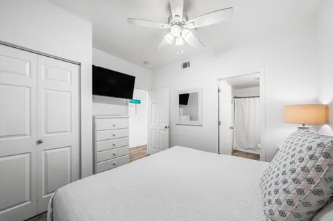 a bedroom with a bed and a flat screen tv
