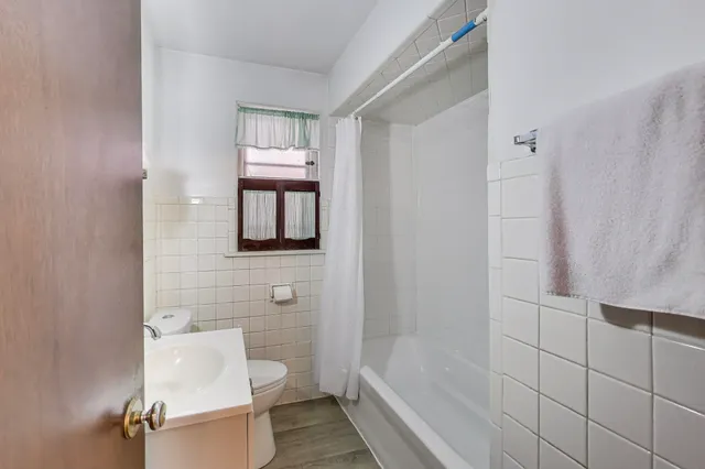 a front view of a house with iron fence