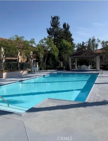 a view of swimming pool with a yard and a fountain