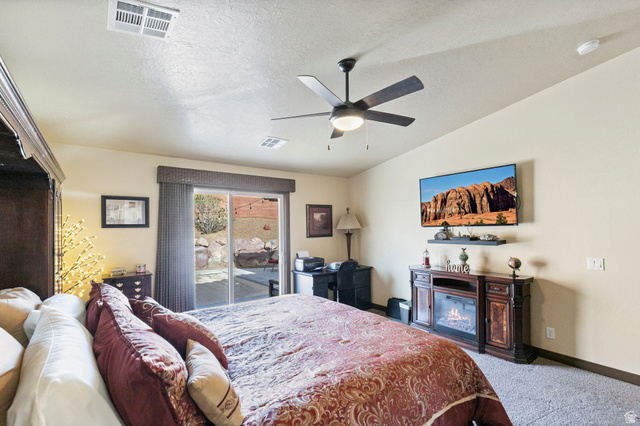 210 Talon Court Ivins, UT 84738 - Photo 29 of 60 Bedroom with access to outside, light carpet, and a ceiling fan