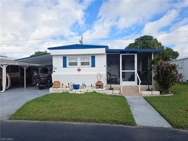 a front view of house with yard barbeque and outdoor seating