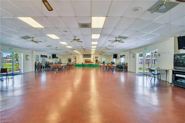 a room with pool tables and windows