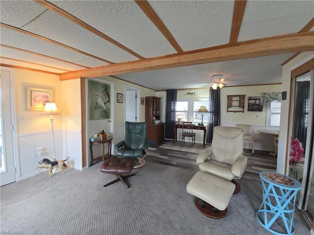 a living room with furniture and a dining table with projector the view