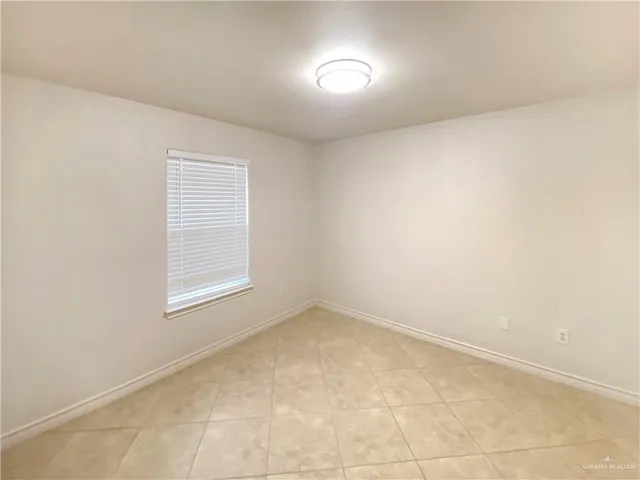 an empty room with a empty space and windows