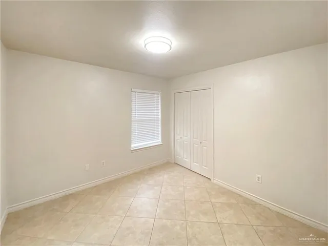 an empty room with a empty space and windows