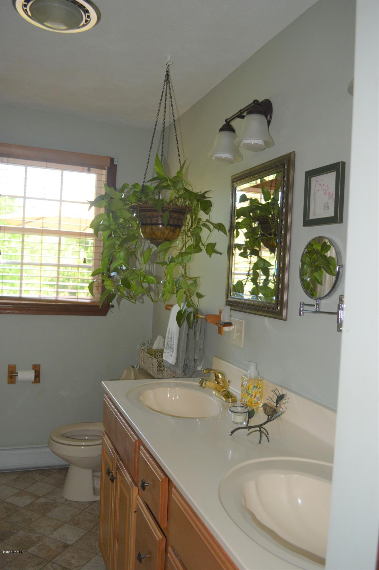 153 Lenox Road Richmond, MA 01254 - Photo 14 of 31 a bathroom with a toilet sink and mirror