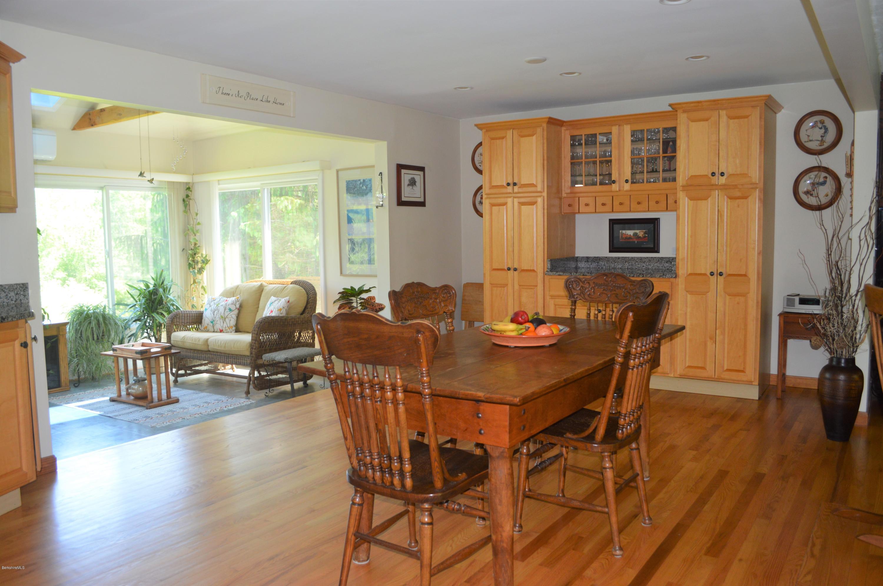 153 Lenox Road Richmond, MA 01254 - Photo 3 of 31 a view of a dining room with furniture and wooden floor