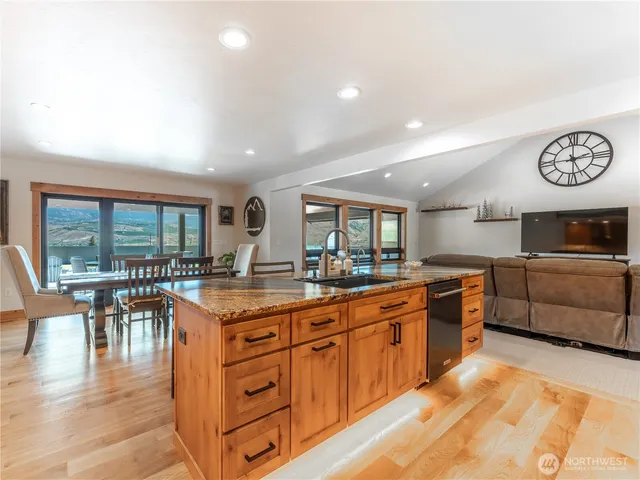 a kitchen with stainless steel appliances granite countertop a stove and cabinets