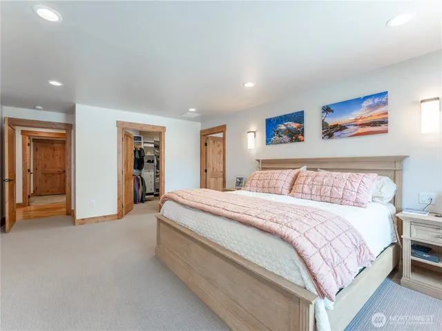 a spacious bedroom with a bed and a walk in closet