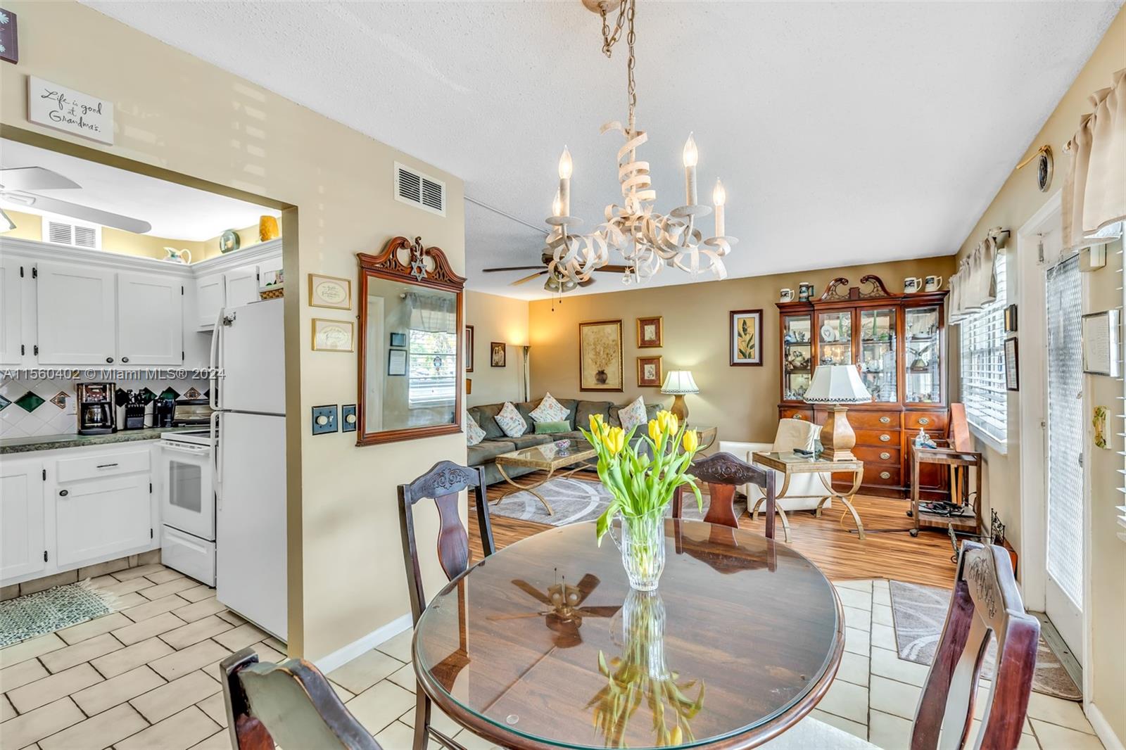 2011 Lyndhurst H, Unit 2011 Deerfield Beach, FL 33442 - Photo 11 of 35 a very nice looking dining room with furniture a chandelier and wooden floor