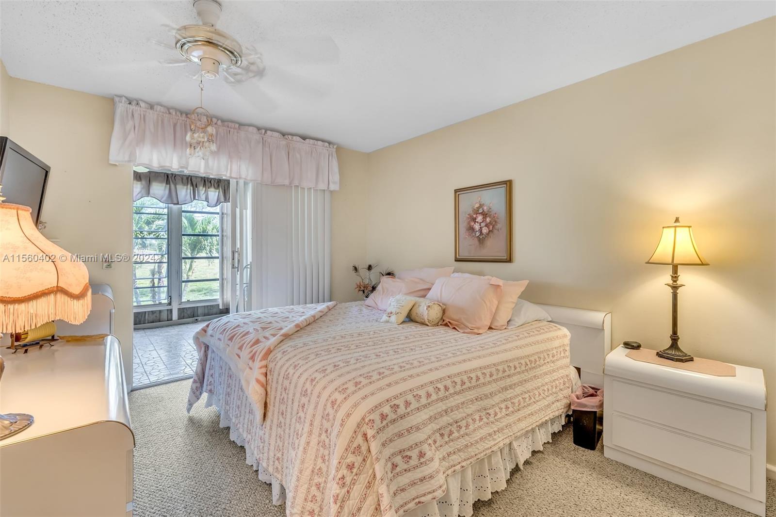 2011 Lyndhurst H, Unit 2011 Deerfield Beach, FL 33442 - Photo 16 of 35 a bedroom with a bed and a window