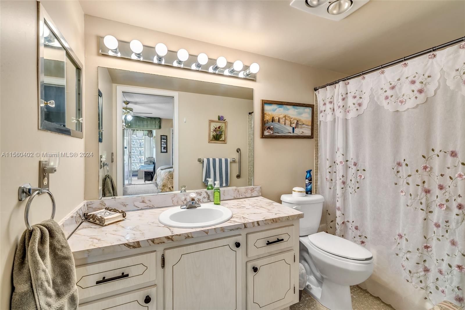 2011 Lyndhurst H, Unit 2011 Deerfield Beach, FL 33442 - Photo 22 of 35 a bathroom with a sink vanity mirror and toilet
