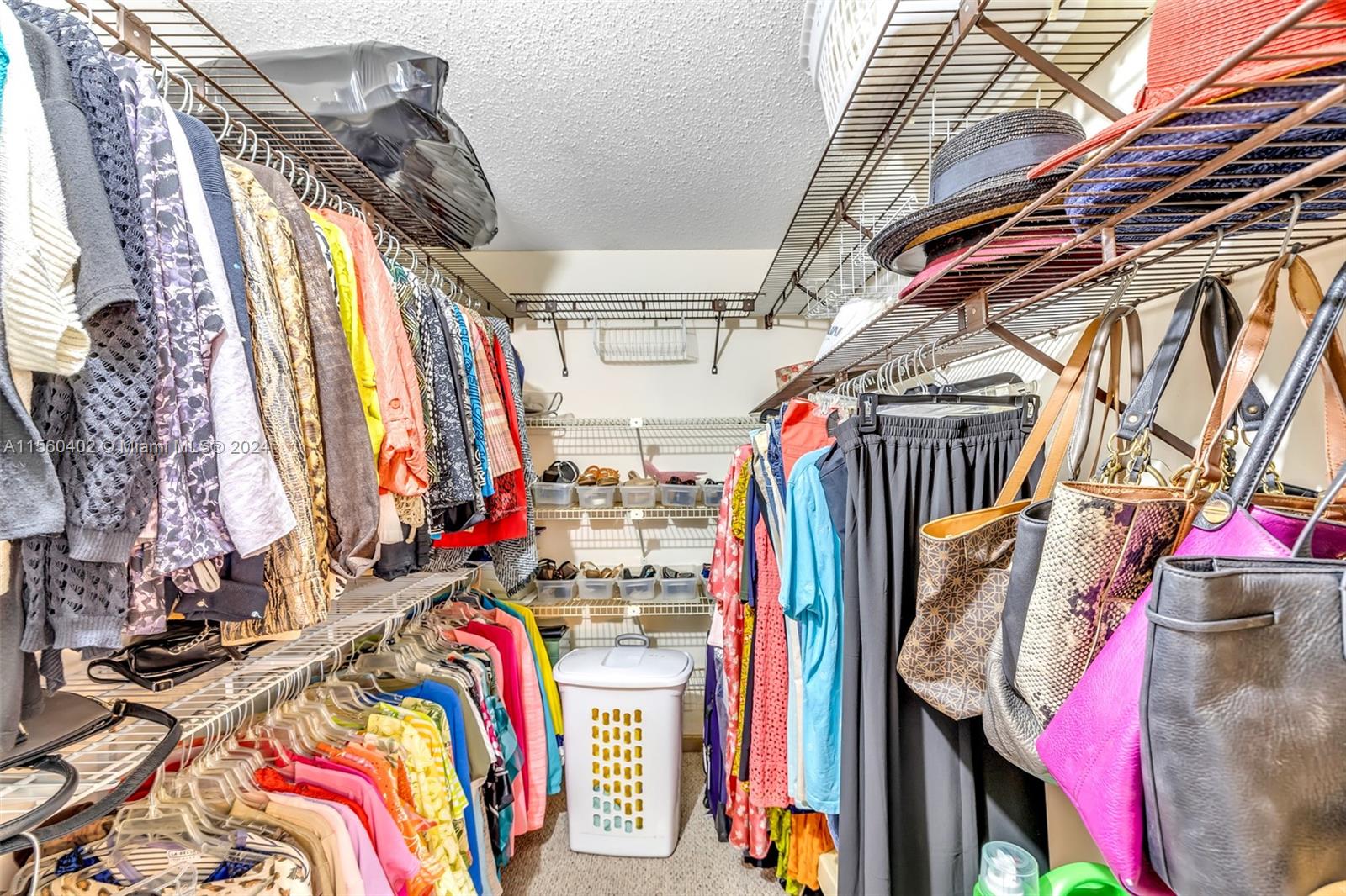 2011 Lyndhurst H, Unit 2011 Deerfield Beach, FL 33442 - Photo 23 of 35 a view of walk in closet with clothes and shoes