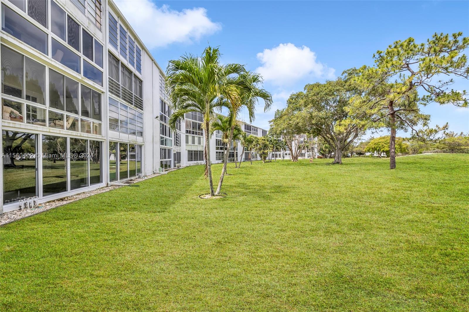 2011 Lyndhurst H, Unit 2011 Deerfield Beach, FL 33442 - Photo 24 of 35 a house with palm tree in front of it