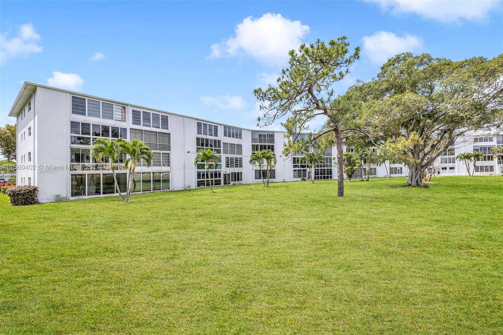2011 Lyndhurst H, Unit 2011 Deerfield Beach, FL 33442 - Photo 25 of 35 a house view with a garden space