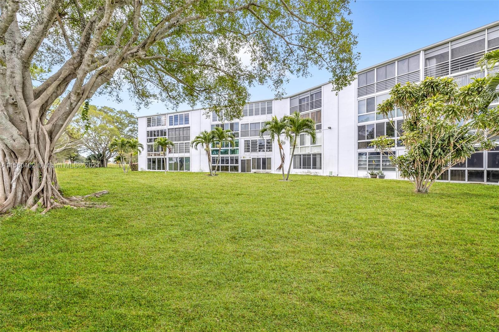 2011 Lyndhurst H, Unit 2011 Deerfield Beach, FL 33442 - Photo 27 of 35 a view of a building with a yard