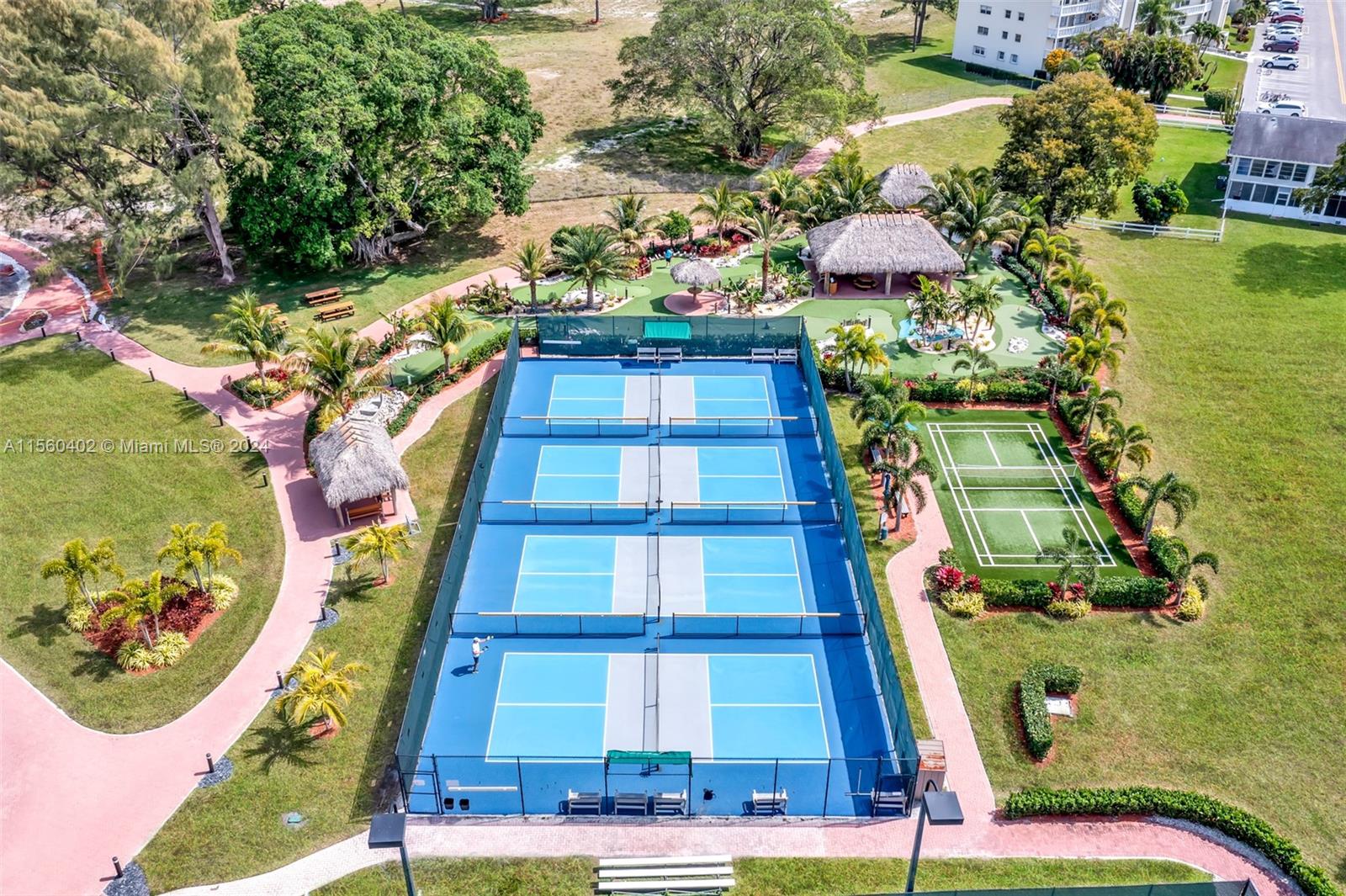 2011 Lyndhurst H, Unit 2011 Deerfield Beach, FL 33442 - Photo 34 of 35 a view of a multi story residential apartment building with a yard