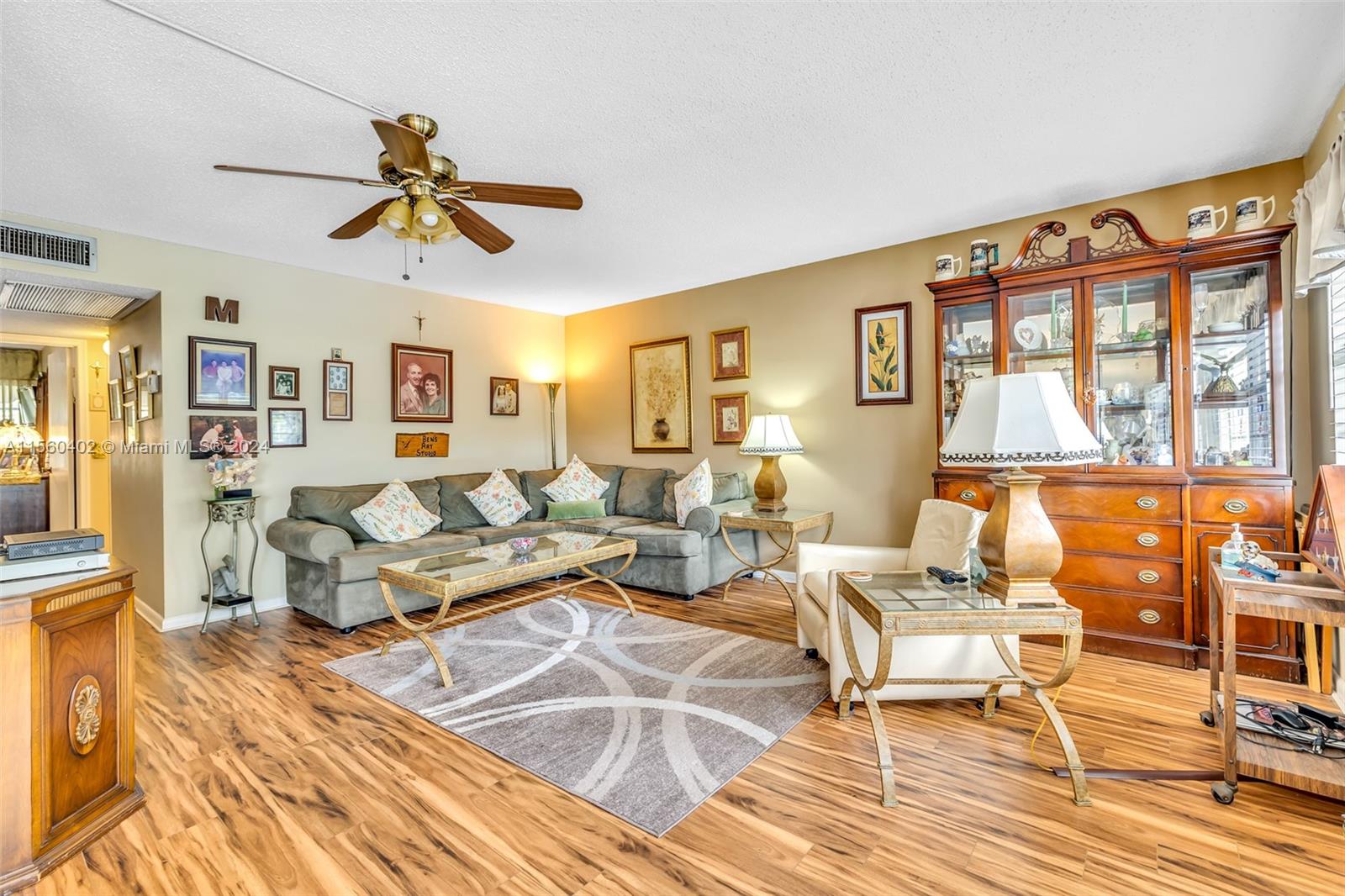 2011 Lyndhurst H, Unit 2011 Deerfield Beach, FL 33442 - Photo 6 of 35 a living room with furniture and a large window