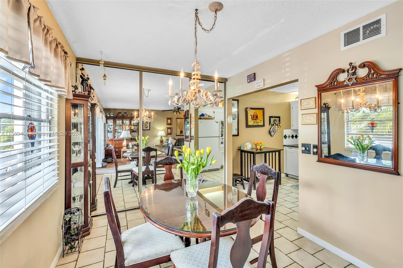 2011 Lyndhurst H, Unit 2011 Deerfield Beach, FL 33442 - Photo 10 of 35 a view of a dining room and livingroom with furniture wooden floor a chandelier