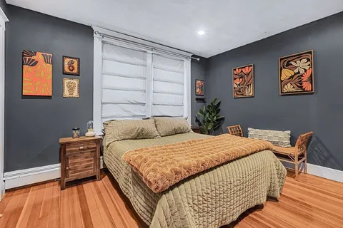a bedroom with a bed and a table