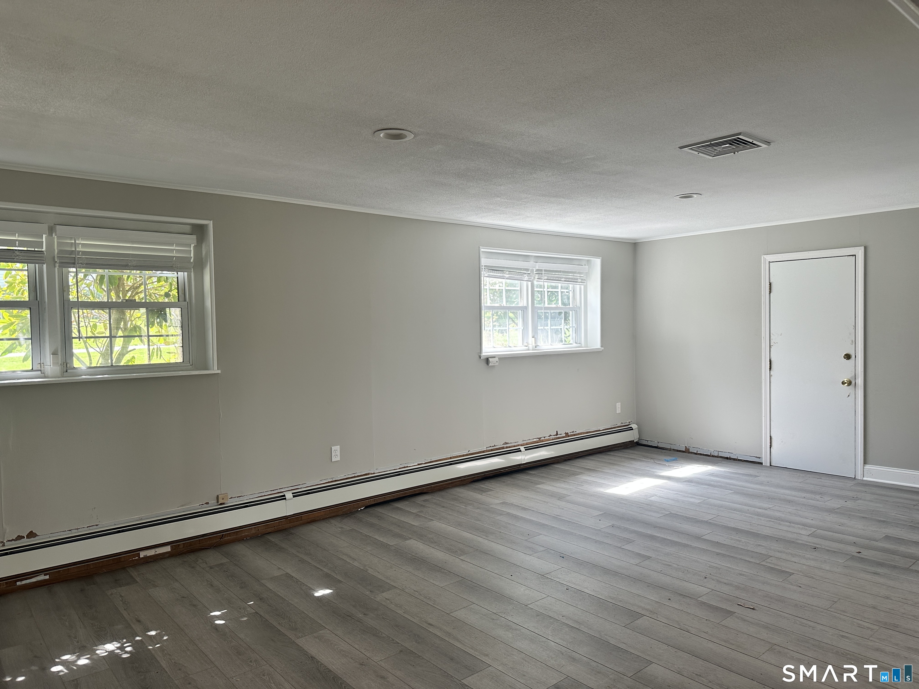 65 Gate Ridge Road Easton, CT 06612 - Photo 12 of 15 an empty room with wooden floor and windows