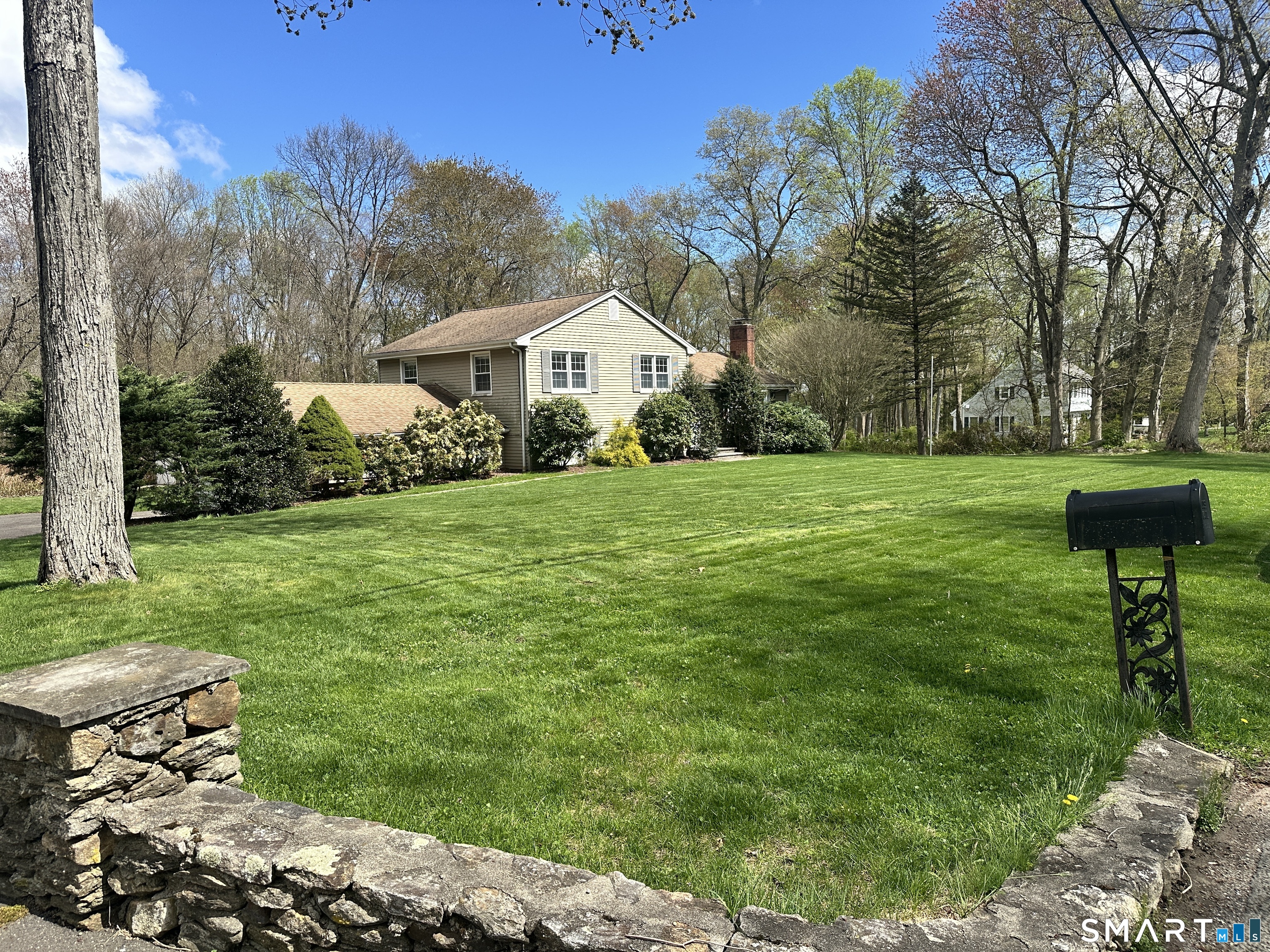 65 Gate Ridge Road Easton, CT 06612 - Photo 2 of 15 a front view of a house with a yard and trees