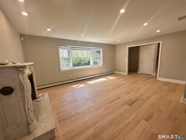 an empty room with windows dryer and washer
