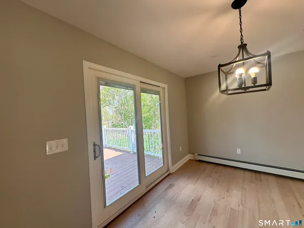 a view of a room with wooden floor and windows