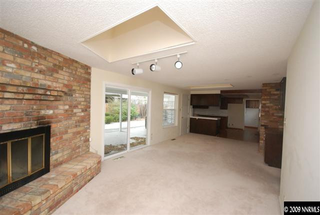 2085 Sharon Way Reno, NV 89509 - Photo 5 of 9 a living room with furniture a fireplace and a flat screen tv