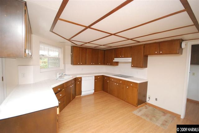 2085 Sharon Way Reno, NV 89509 - Photo 6 of 9 a kitchen with stainless steel appliances granite countertop a sink a stove and cabinets