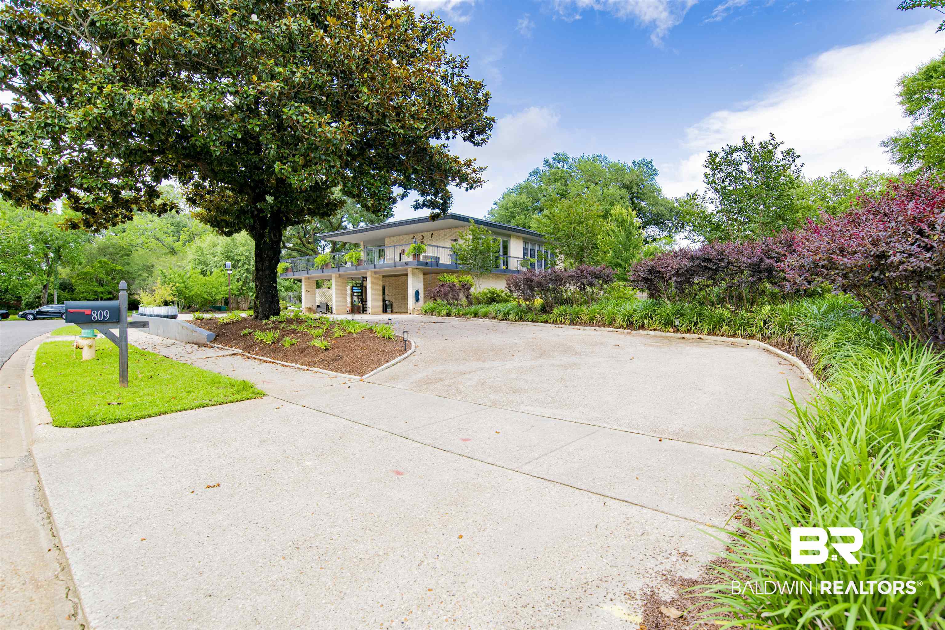 809 Bernard Circle Mobile, AL 36693 - Photo 51 of 75 Circular driveway leading to a multi-level residence with a second-story balcony