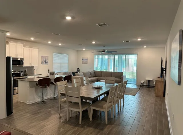 a group of dining room furniture and wooden floor