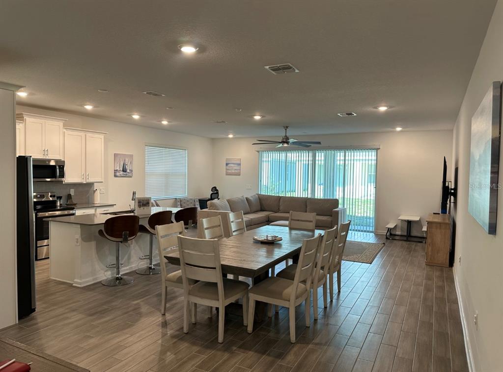 2759 Slash Way St. Cloud, FL 34771 - Photo 11 of 45 a group of dining room furniture and wooden floor