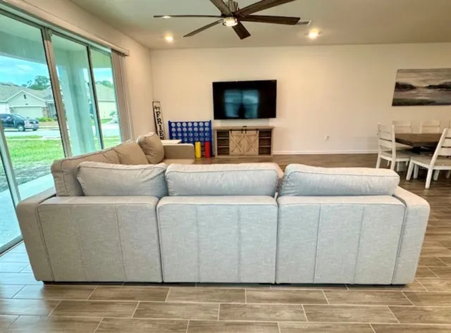 a living room with furniture and a flat screen tv