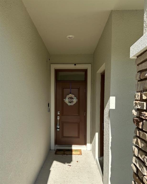 2759 Slash Way St. Cloud, FL 34771 - Photo 14 of 45 a hallway with sliding door and yard